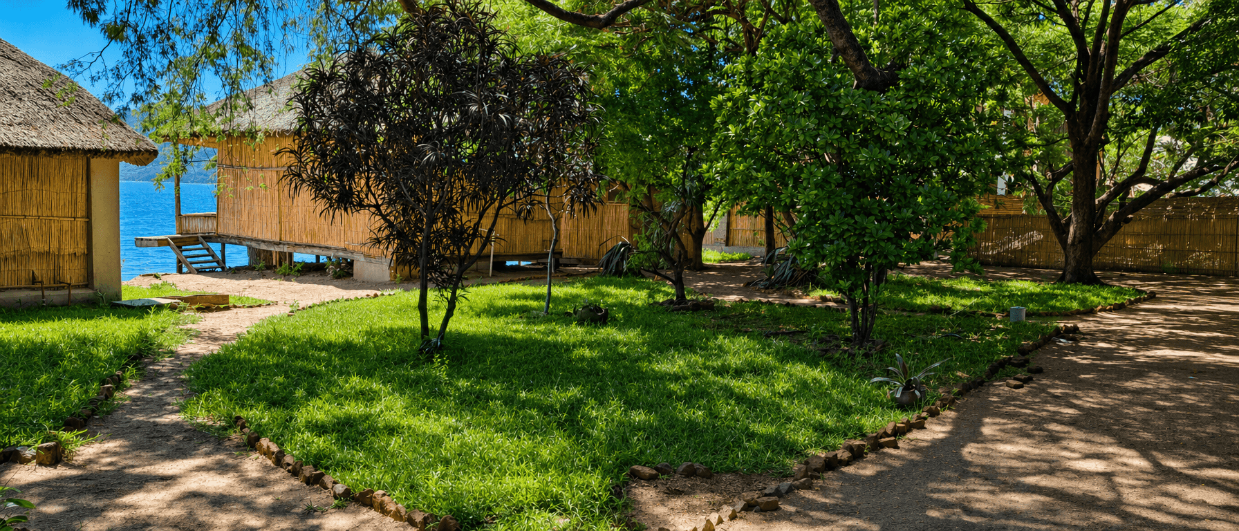Lakeside chalets and gardens at Anake Lodge