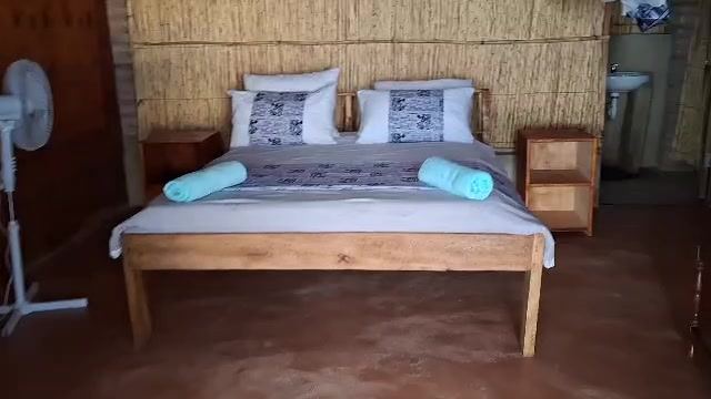 Standard Room: Double bed with fan in the Tumbuka room, Anake Lodge, Cape Maclear – photo 10 of 12